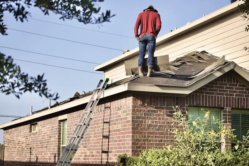Professional roofer working on a residential roof in Niles Junction
